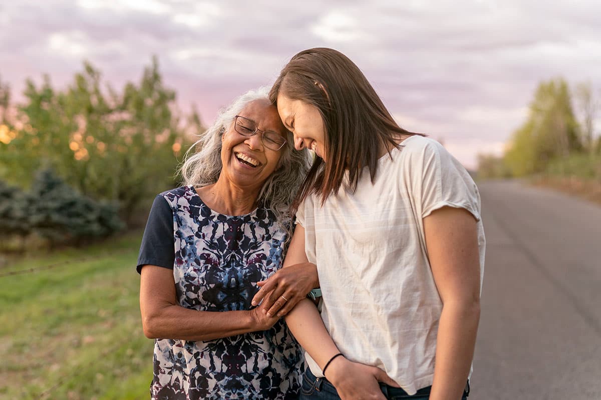an older woman laughing, arm in arm with a younger woman on a country road, after gallbladder surgery in Marion & Mount Vernon
